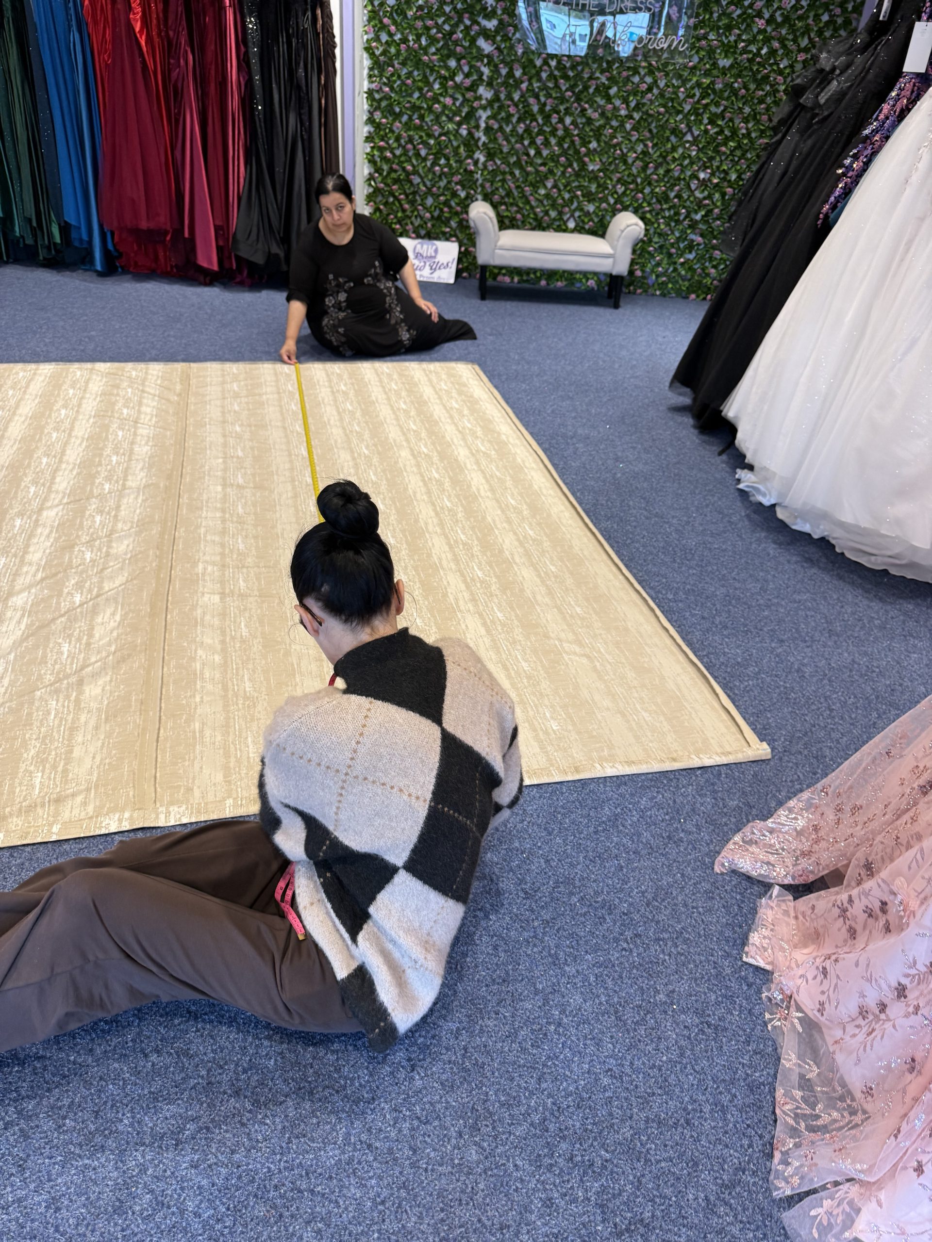 MK Seamstress team measuring curtain fabric in the Bletchley showroom